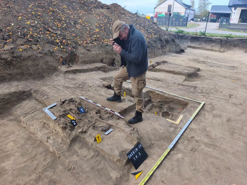An expert photographs human remains, likely belonging to a Ukrainian killed in 1944 in the village of Łasków, Lublin Voivodeship, Poland. October 2026.