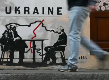 A man walks past a mural by Norwegian street artist Toddel depicting a map of Ukraine and US President Donald Trump (L) with Russia's President Vladimir Putin in Krakow on March 6, 2026, amid the Russian invasion of Ukraine. (Photo by Sergei GAPON / AFP) / Eastnews)