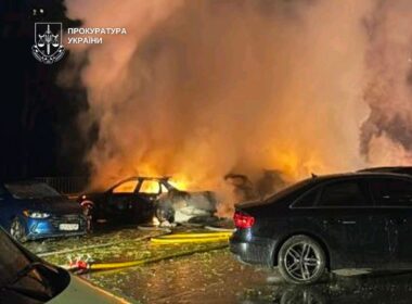 Cars burning outside a 25-story apartment building in Kyiv after a Russian drone strike